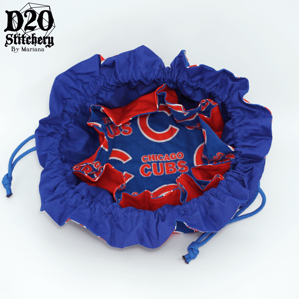 Open epic dice bag with Chicago Cubs in red and big red C on blue background tied with blue background showing matching interior fabric, blue outer lining, red pocket lining, and 8 pockets.