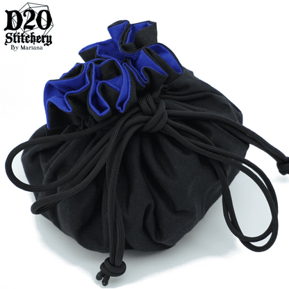 Epic dice bag with royal blue lining and black exterior fabric tied with black paracord.