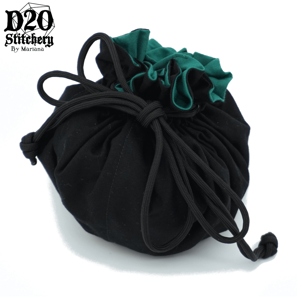 Epic dice bag with forest green lining and black exterior fabric tied with black paracord.