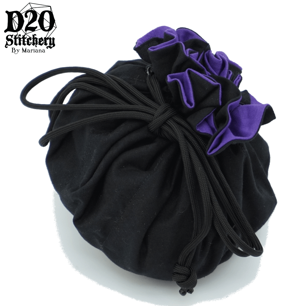 Epic dice bag with medium purple lining and black exterior fabric tied with black paracord.