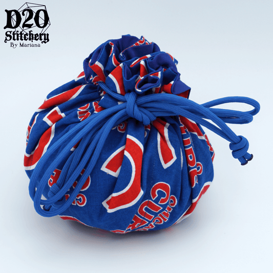 Epic dice bag with Chicago Cubs in red and big red C on blue background tied with blue paracord.