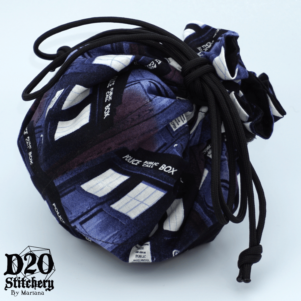 Epic dice bag with Dr. Who Police Call Box Corner View fabric tied with black paracord.