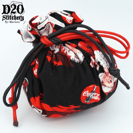 Epic dice bag with Coca-Cola Santa and logo on black background tied with black and red paracord.